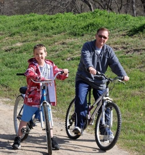 Man and son riding bikes at Mill Creek Ranch Resort