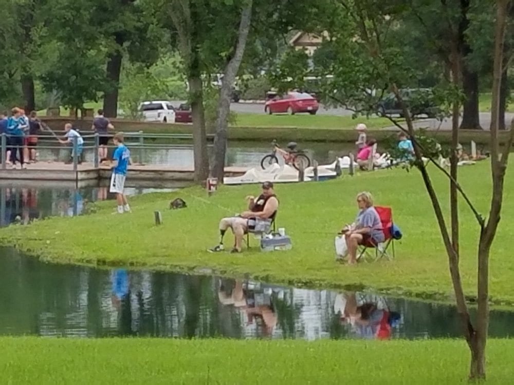 People fishing and playing at a pond in Canton, TX