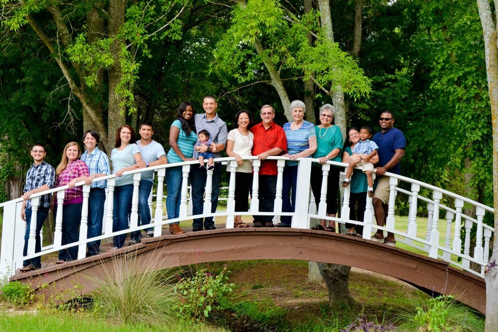 Family reunion in Canton, TX with family group standing on a bridge