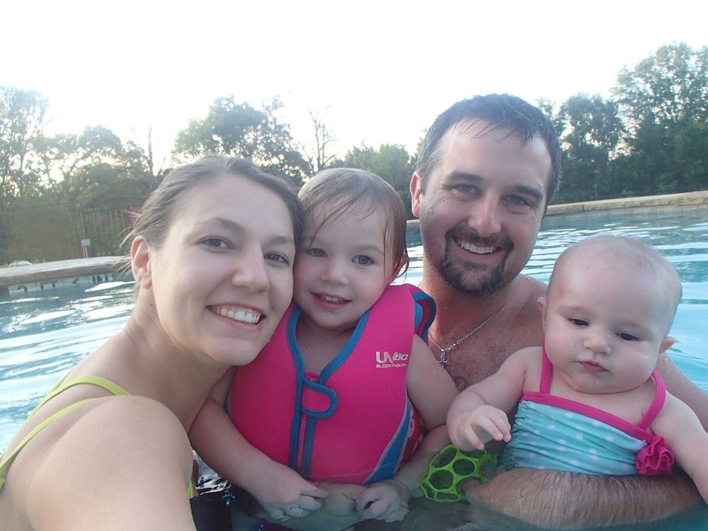 Happy family in the Grand Lodge pool at Mill Creek Ranch Resort