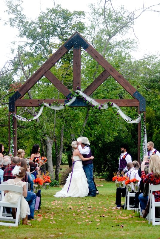 Newlyweds kiss at outdoor wedding in East Texas