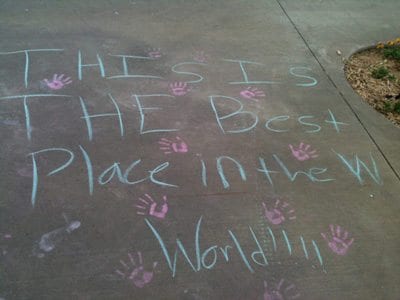 Sidewalk chalk reading "This is The Best Place in the World"