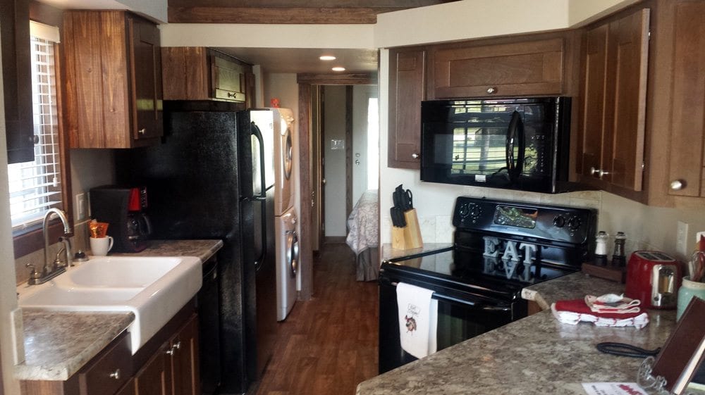 Full kitchen with fridge, stove and amenities in Cabin 7 at Mill Creek Ranch Resort