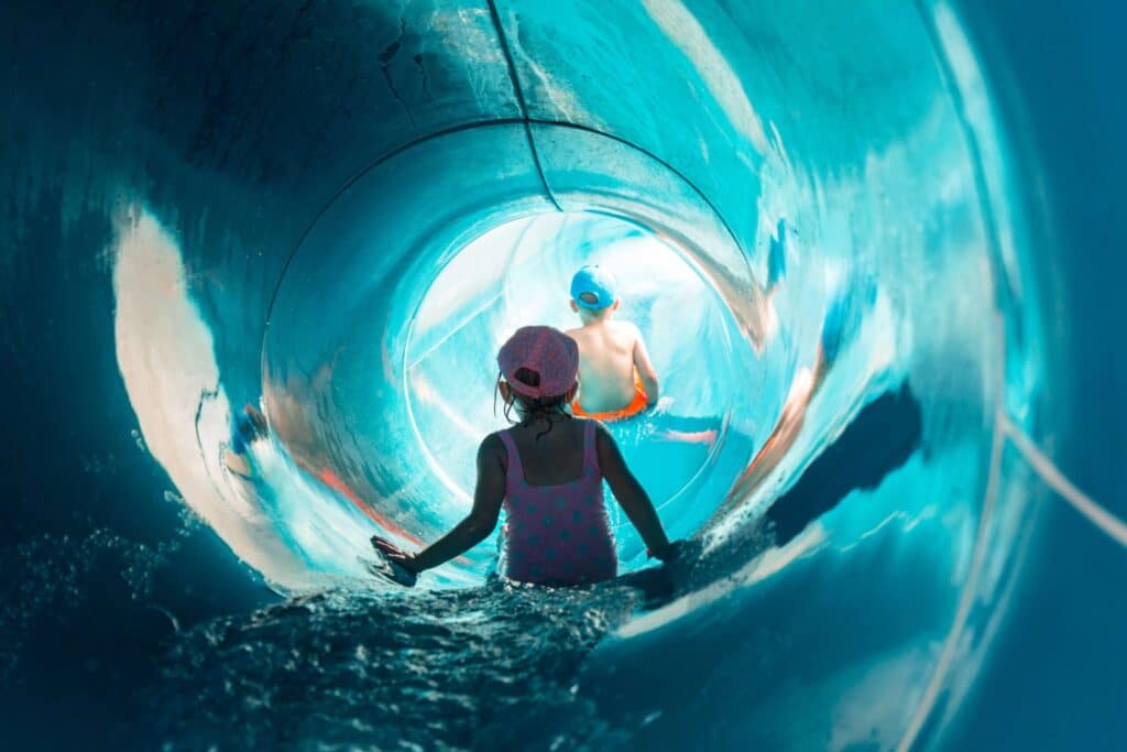 A child in a water slide enjoying Places To Swim In Texas.