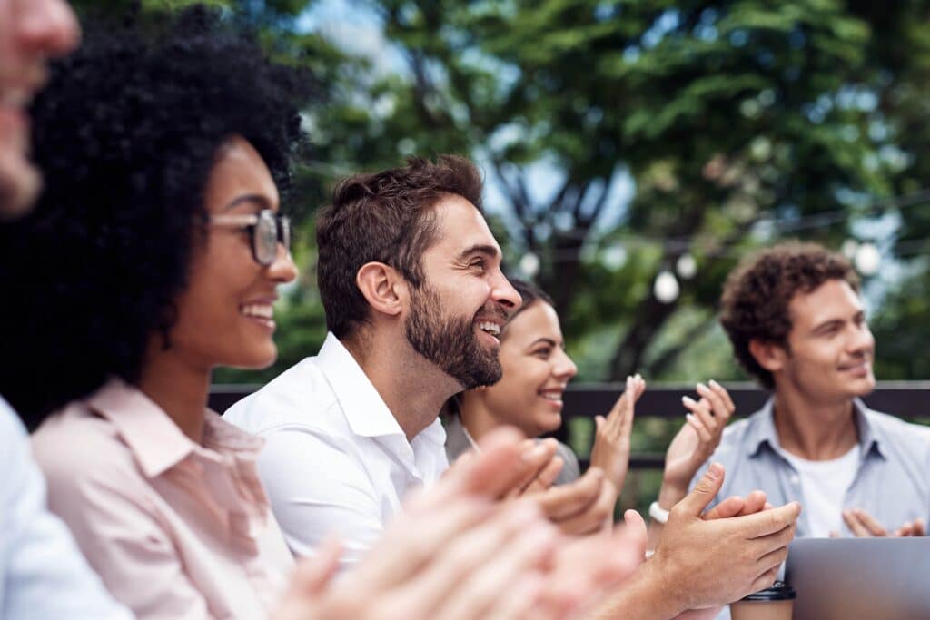 A group of people clapping during a Corporate Retreat.