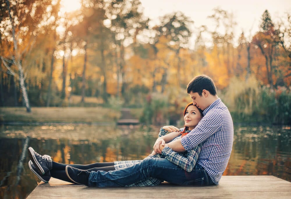 Photo of a Couple Snuggling near a Pond at Mill Creek. Click Here for 15 Fall Date Ideas near Dallas!