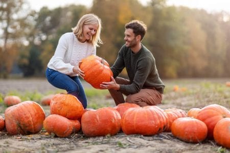 Photo of a Couple at a Pumpkin Patch. Click Here for 15 Fall Date Ideas near Dallas.
