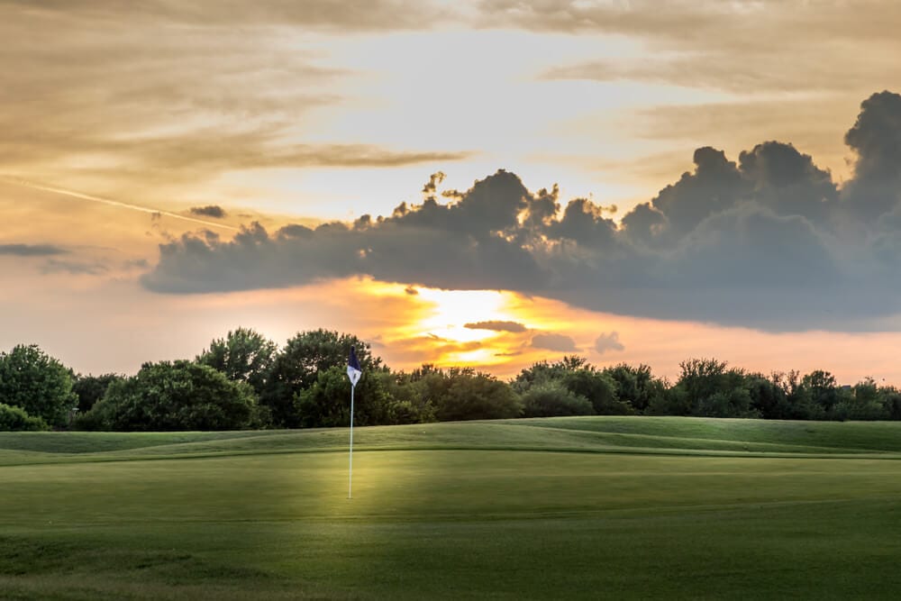 Photo of a Pristine Green with a Sunset Backdrop at One of the Best East Texas Golf Courses.